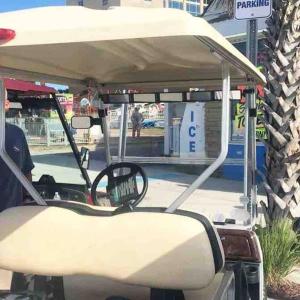 a golf cart with the front windshield and steering wheel at Luxury Townhouse w/ Golf Cart & Private Elevator in Carolina Beach
