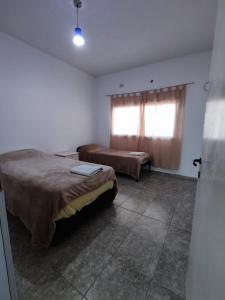 een kamer met 2 bedden en een raam erin bij Amplio dpto y luminoso in San Fernando del Valle de Catamarca