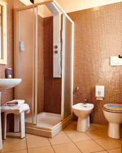 a bathroom with a shower and a toilet at Hotel Villabella in San Bonifacio