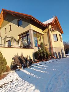 a house with snow in front of it at Agroturystyka u Rysia in Kamienna