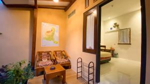 a hallway with two dolls in a room at Nitha Homestay Near Train Station in Banyuwangi