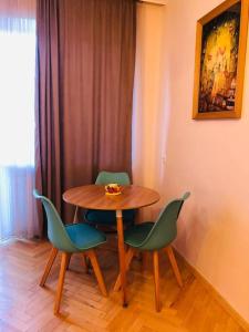 a table and four chairs in a room at Cozy flat in the middle of Tbilisi in Tbilisi City