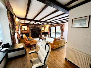 a living room with couches and a fireplace at Reads Cottage in Waterlooville