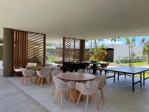 a restaurant with tables and chairs and a patio at Porto Beach Resort - Makia Beach Experience in Porto De Galinhas