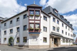 a large white building with windows and plants on it at Hotel Trapp in Rüdesheim am Rhein