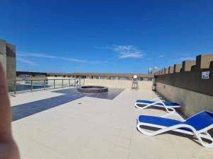 a pair of blue and white lounge chairs on a roof at Studio in Dubai