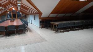 a large room with a long table and chairs at Почивна станция - ТЕЦ Бобов дол in Bistriza