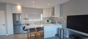 a kitchen with a counter and a sink and a refrigerator at SeeSkattie in St. Helena Bay
