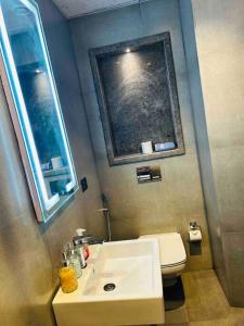 bagno con lavandino bianco e servizi igienici di AmigosStay - High Rise Studio with river view. a Noida