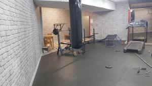 a gym with several equipment in a brick wall at Почивна станция - ТЕЦ Бобов дол in Bistriza