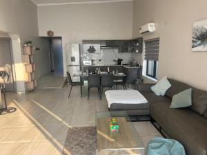 a living room and kitchen with a couch and a table at Escapes in Cape Maclear