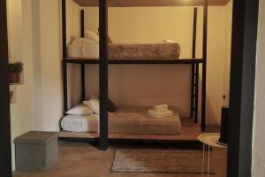 a room with two bunk beds with towels on them at OutBox Inn in Monteverde Costa Rica