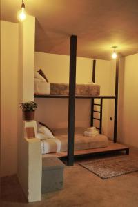 a bedroom with two bunk beds in a room at OutBox Inn in Monteverde Costa Rica