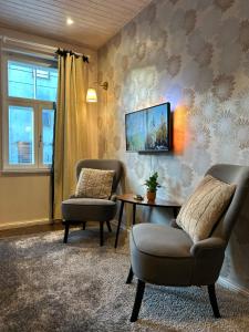 a living room with two chairs and a table at Garden Studio next to Telliskivi & Old Town in Tallinn