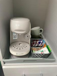 a shelf in a refrigerator with a coffee maker and other items at Cosy Jungle Cabin With Bathroom in Bircotes