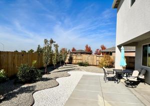 a patio with a table and chairs and a fence at Modern Ripon Home - Whole House with Garage in Ripon