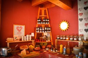 a kitchen with a table with food on it at Logis Hôtel Restaurant La Petite Auberge Alsace in Le Hohwald