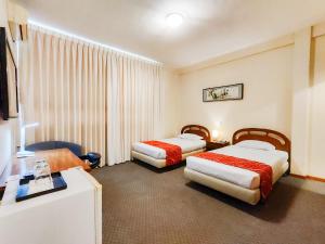 聖克魯斯的住宿－Hotel Lido，酒店客房设有两张床和电视。