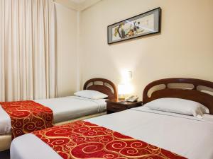 Un pat sau paturi într-o cameră la Hotel Lido