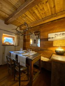 a wooden dining room with a table and chairs at On the pistes of Sauze in Sauze dʼOulx