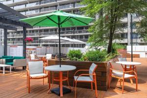 a table with a green umbrella on a patio at Holiday Inn Toronto Downtown Centre by IHG in Toronto