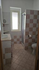 a bathroom with a toilet and a sink at Azienda Agricola Gentile - la casa degli ulivi in Vieste