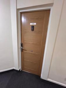 a wooden door with a sign on it in a room at Lucid Magic Dream in Limerick