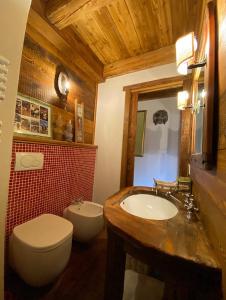 a bathroom with a white toilet and a sink and a toilet at On the pistes of Sauze in Sauze dʼOulx