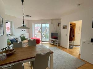 a living room with a table and chairs and a living room at Apartment Raum in Fehmarn Orth in Orth
