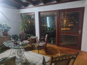 a living room with a glass table and chairs at Apartments Amy in Sarajevo