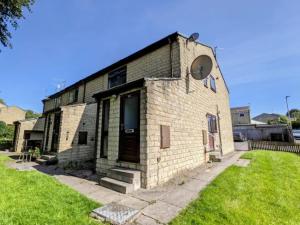 a brick building with a window and a door at K Suites - Harrogate Terrace in Bradford