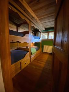 a room with two bunk beds in a cabin at On the pistes of Sauze in Sauze dʼOulx