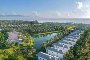 an aerial view of a resort complex with water and palm trees at Danang Marriott Resort & Spa, Non Nuoc Beach Villas in Da Nang