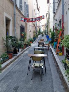 an empty street with tables and chairs in an alley at Appartement T2 40m2 Rénové Au Coeur du Panier Vieux Port in Marseille