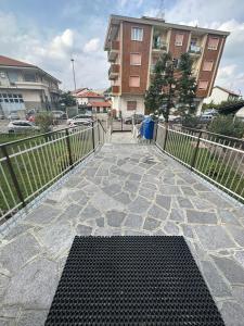 a stone patio with a fence and a building at Cozy home baranzate in Baranzate