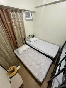 a bedroom with two bunk beds and a window at BGC-Ortigas Link Condo in Manila