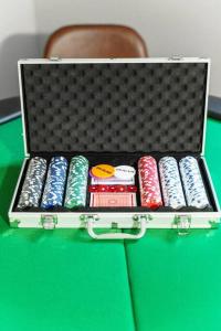 a briefcase filled with different colored batteries on a green table at Casa Hermes in Hamptons in Westhampton Beach