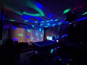 a room with blue and green lights and a table at Peter Pan Poolvilla in Jomtien Beach +64 photos
