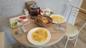 a table with two plates of food and a coffee maker at MidCity Hotel in Baku
