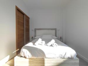 マラガにあるOhana home 2のベッドルーム1室(白いベッド1台、タオル2枚付)