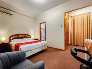聖克魯斯的住宿－Hotel Lido，一间卧室配有一张床、一张桌子和一把椅子