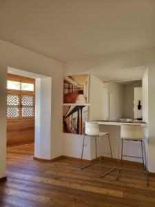 a kitchen with two chairs and a table in a room at La Casa dei Turchi in Rovereto