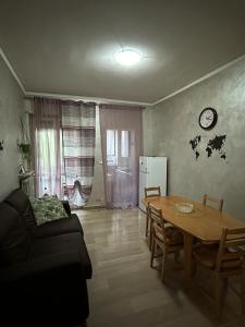 a living room with a table and a couch at Da Tiziana in Turin