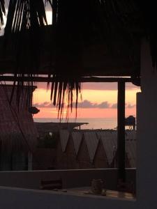 a view of the ocean from a building with a sunset at Linda casita cerca al mar. in Máncora
