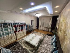 a room with bunk beds in a room with a rug at GREEN WEST House in Bishkek