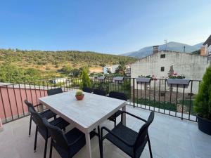 a table and chairs on a balcony with a view at Apartamentos La Flor in San Martín de Moncayo