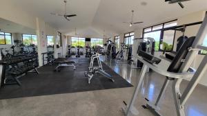 a gym with treadmills and machines in a room at New 3 bedroom Home in Managua in Managua