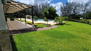 a backyard with a swimming pool and a pavilion at New 3 bedroom Home in Managua in Managua