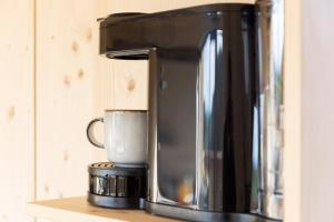 a coffee maker sitting on top of a counter at Streuobst Chalets in Neukirch