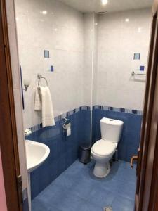 a blue and white bathroom with a toilet and a sink at Hrashq Hotel in Yerevan +4 photos